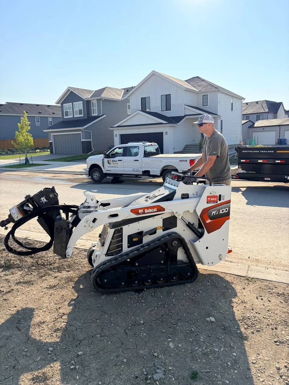 Nika Terra Bobcat MT100 mini track loader at a residential job site in Calgary