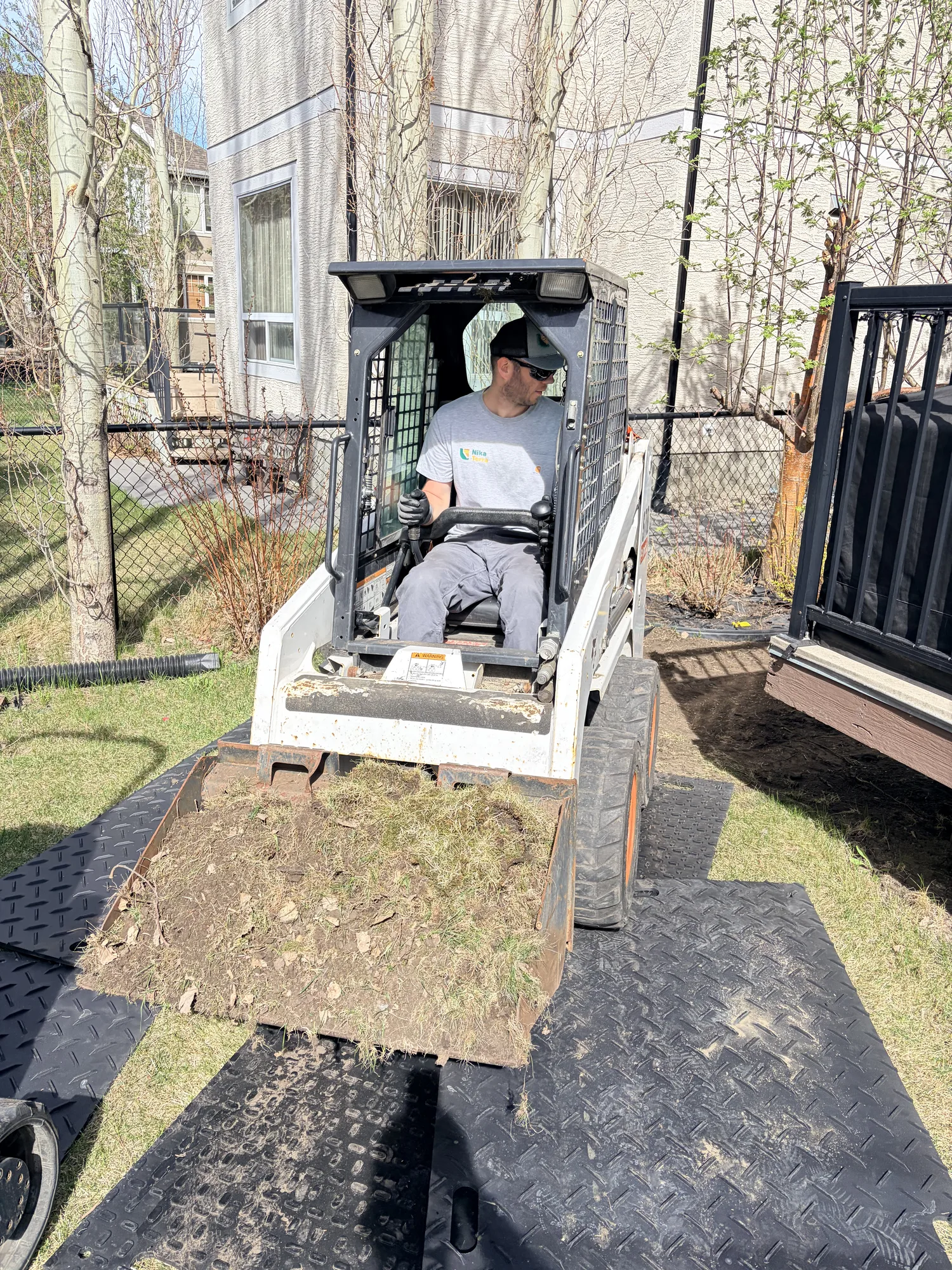 Mini skid steer loader for grading and material handling on Calgary job sites