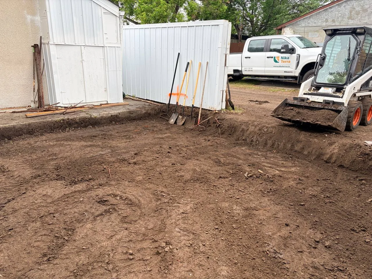 Compact equipment used for backyard soil excavation and site preparation in Calgary