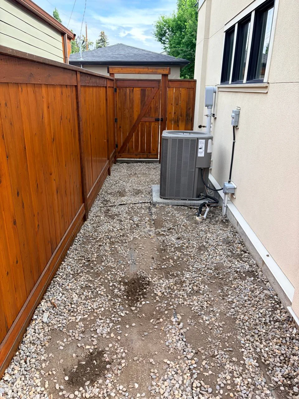 Side yard decorative rock area before settlement repair in Calgary