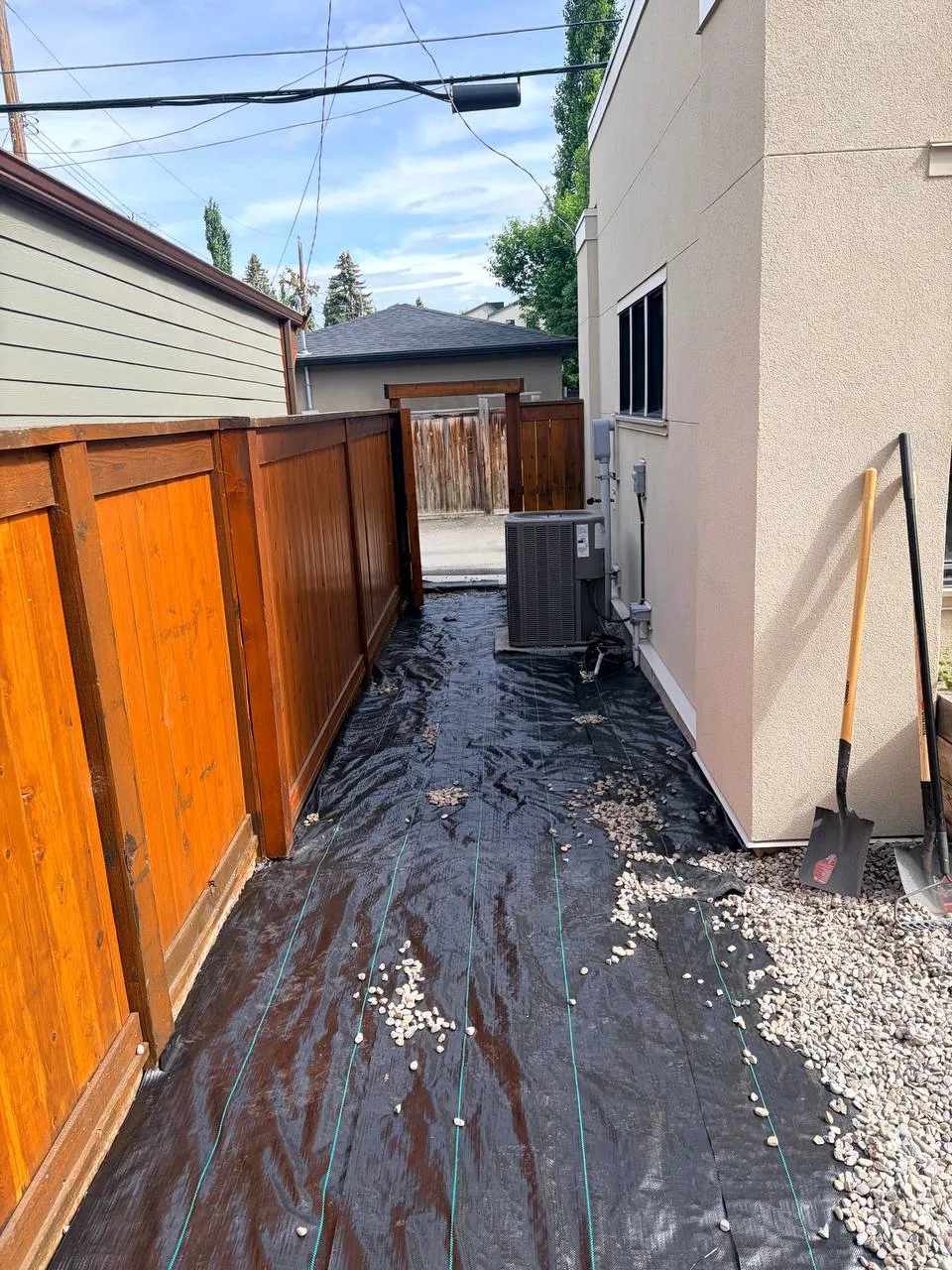 Weed barrier installed in a Calgary side yard before decorative rock placement
