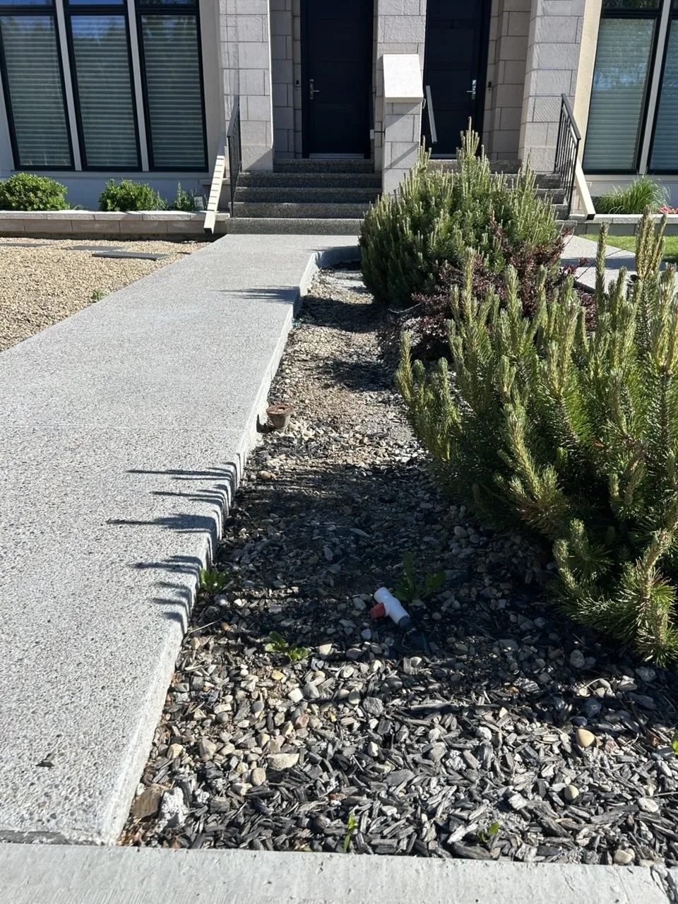 Left-side Calgary front yard bed before Tan Rock refresh