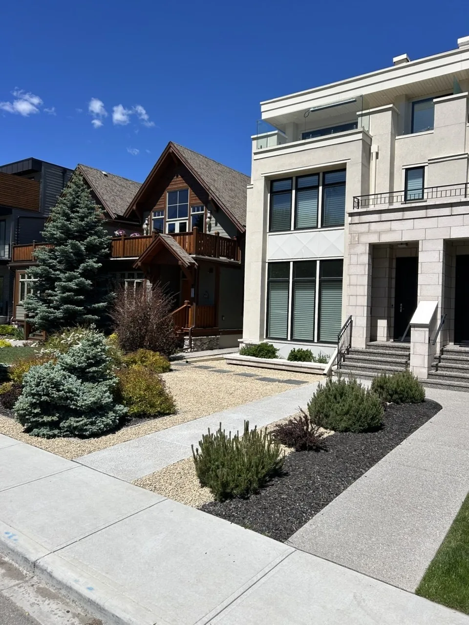 Wide view of left-side front Tan Rock bed after installation in Calgary