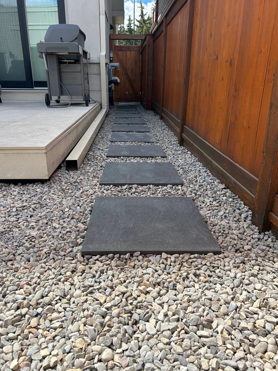 Stepping stone walkway reset in decorative rock in Calgary
