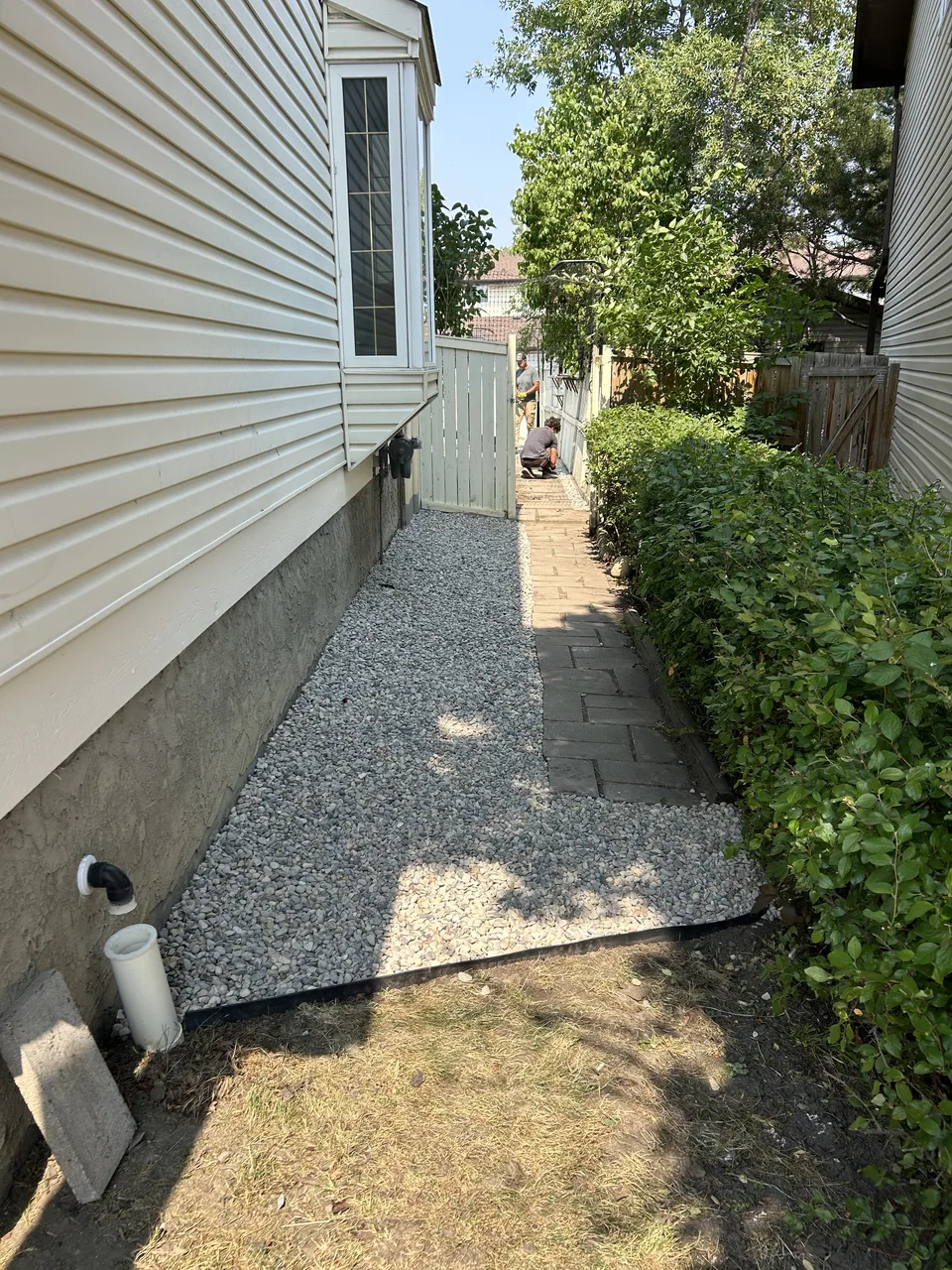 Calgary side walkway after weed removal and decorative rock installation