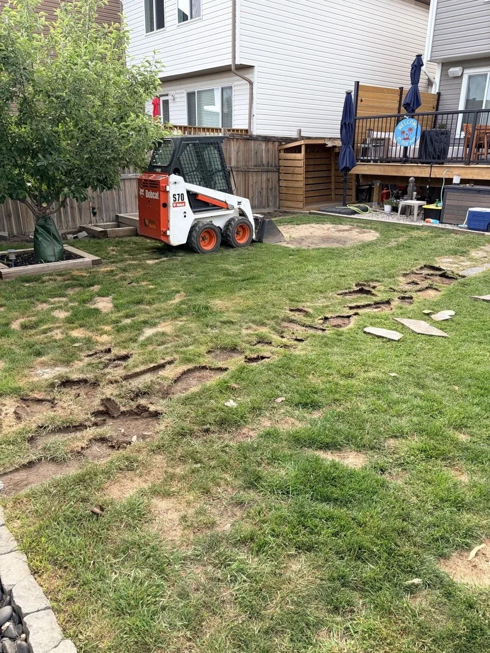 Calgary backyard before sod and topsoil removal for road crush base installation