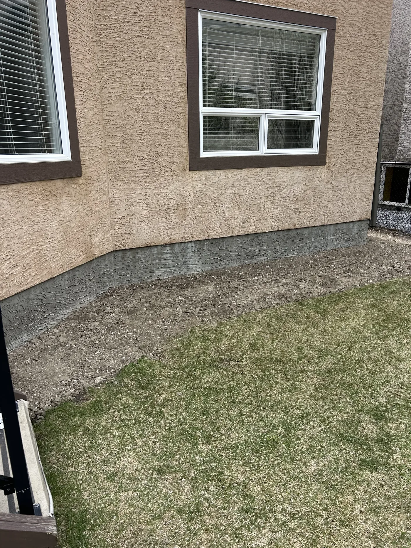 Backyard foundation edge during cleanup and soil removal in Calgary