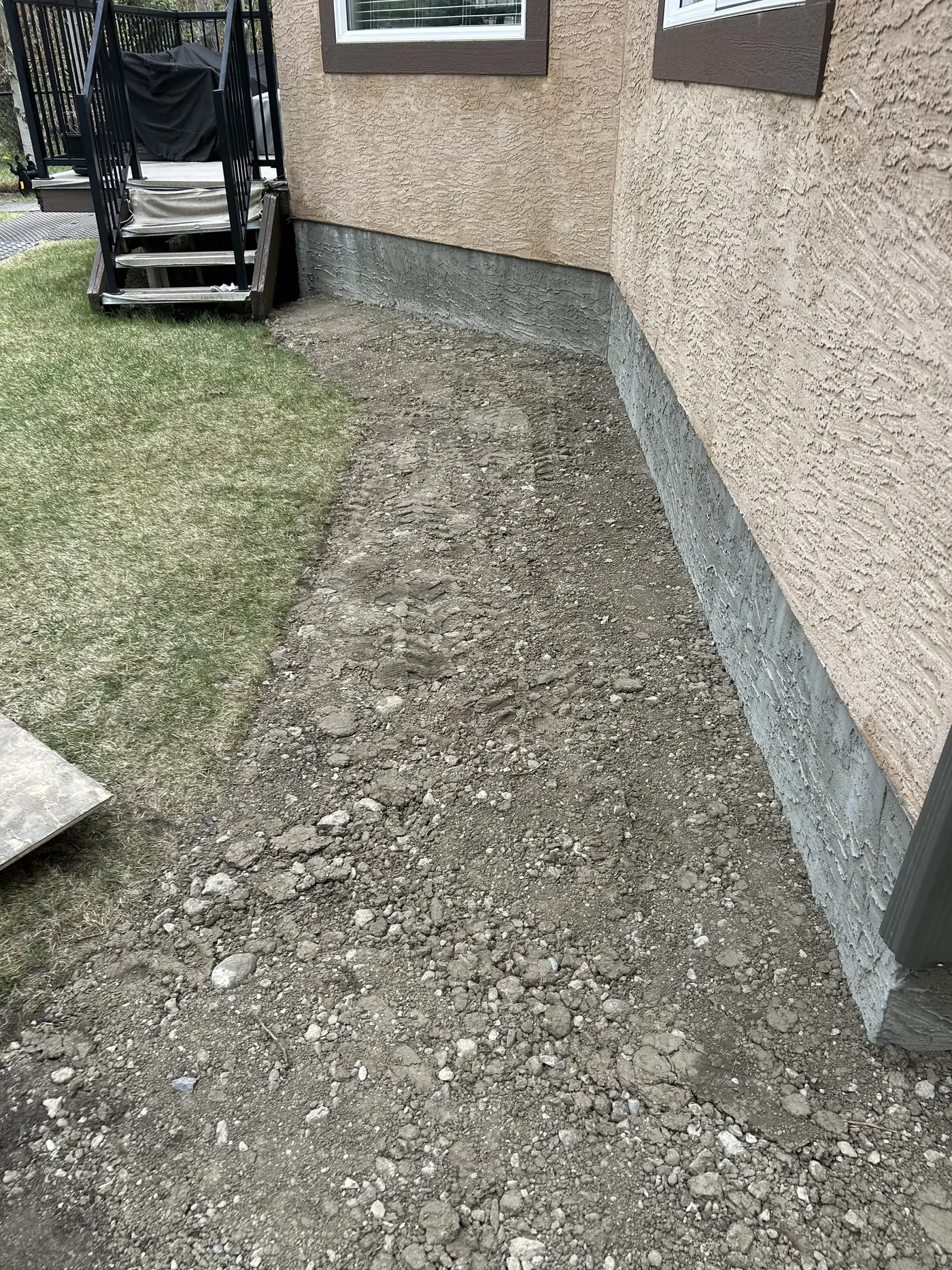 Backyard foundation edge after grading preparation in Calgary