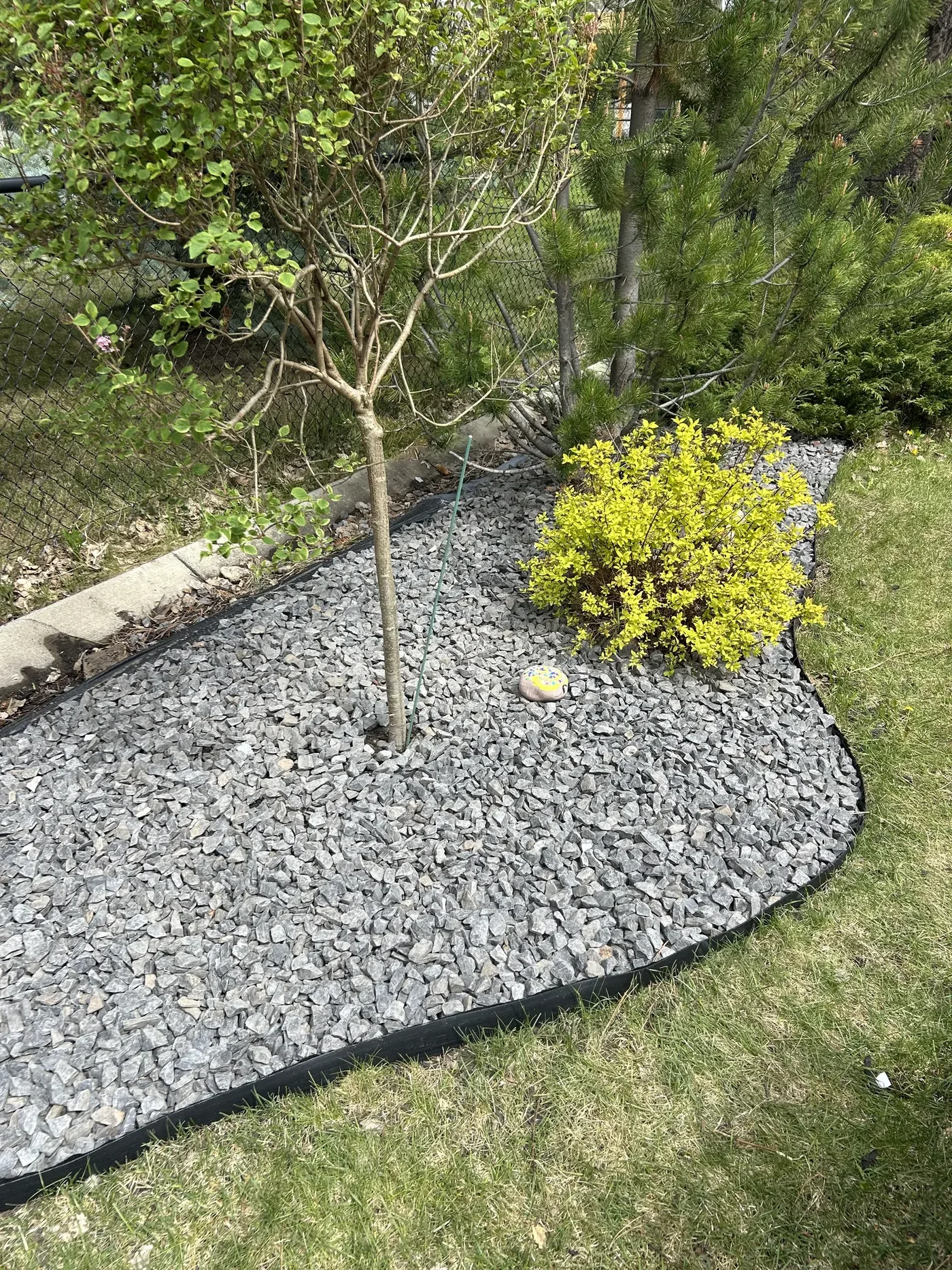 Finished garden bed with decorative Rundle Rock in Calgary