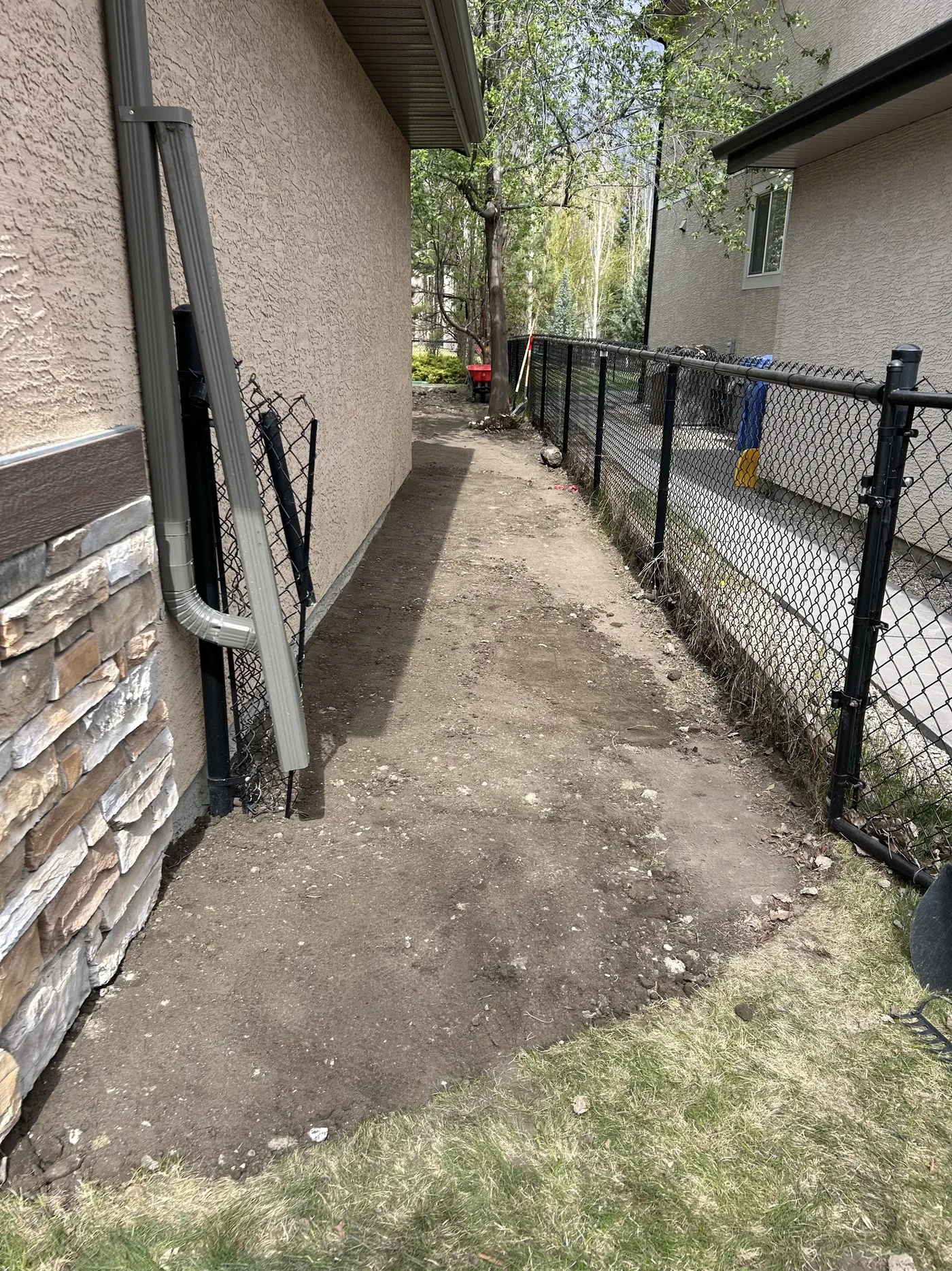 Front gate approach after final grading before rock installation in Calgary
