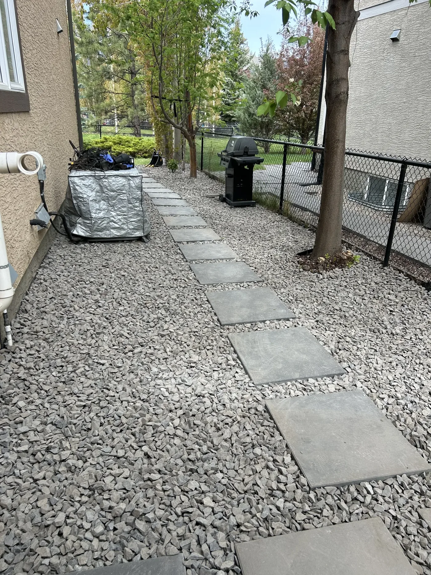 Finished Calgary side yard with Rundle Rock and a concrete stepping stone pathway